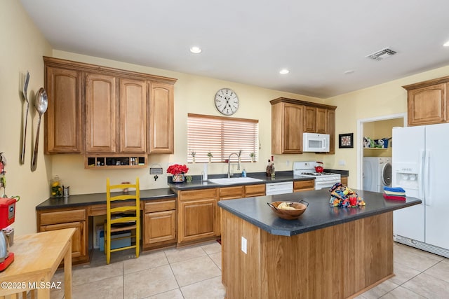 13076 N Desert Olive Dr, Oro Valley, AZ 85755 - kitchen featuring white appliances, light tile patterned floors, dark countertops, visible vents, and a sink