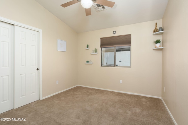 unfurnished room with baseboards, carpet floors, visible vents, and a ceiling fan