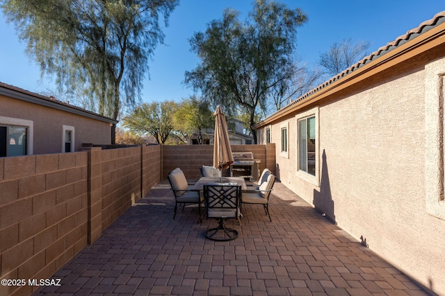 view of patio / terrace with a fenced backyard and outdoor dining space