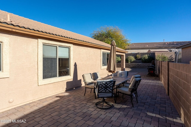 view of patio / terrace with outdoor dining space and a fenced backyard