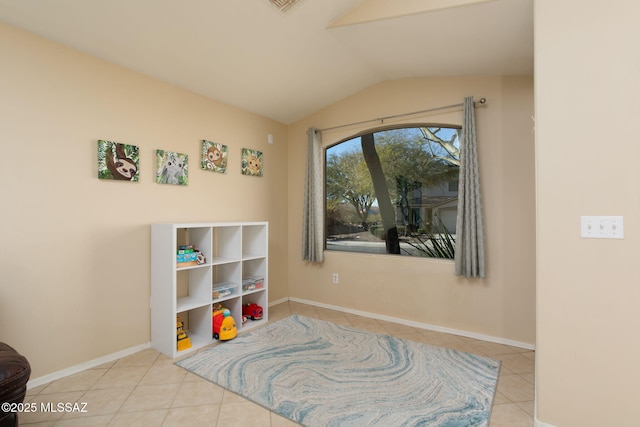 game room with tile patterned flooring, baseboards, and vaulted ceiling