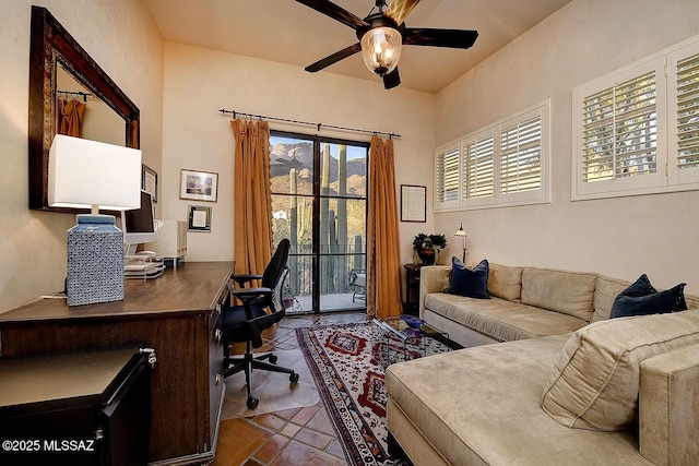 office featuring a ceiling fan and dark tile patterned floors