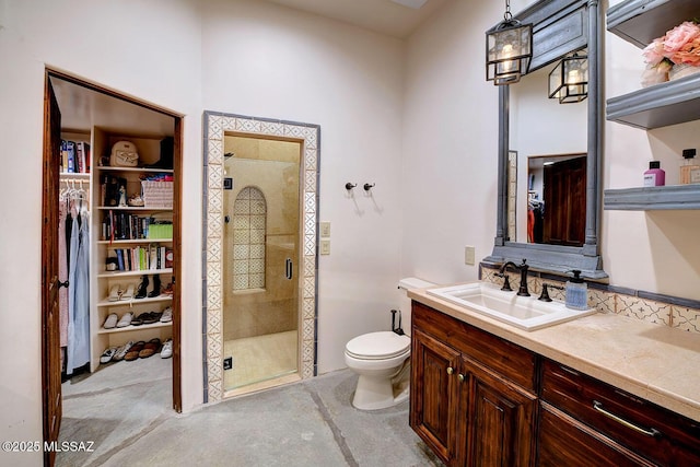 full bathroom featuring a spacious closet, a stall shower, vanity, and toilet