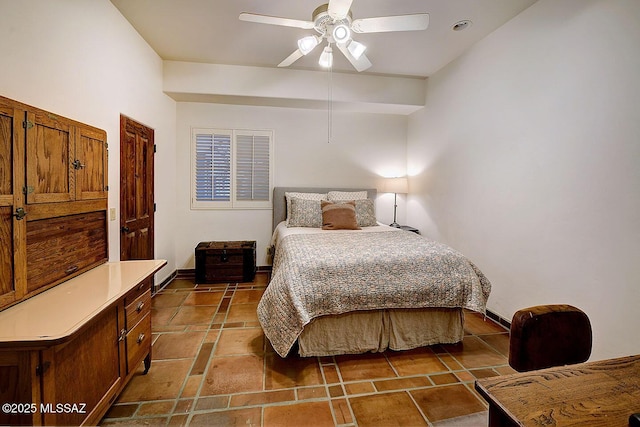 bedroom featuring baseboards and a ceiling fan