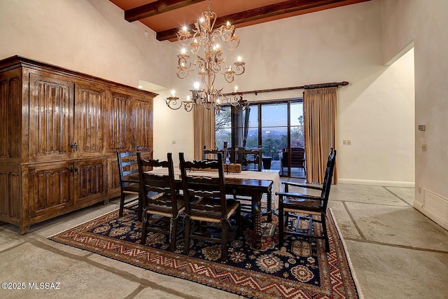 dining area featuring a chandelier, a towering ceiling, baseboards, beamed ceiling, and stone tile flooring