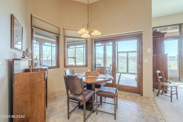 dining space featuring a chandelier and light tile patterned flooring