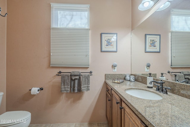 half bathroom featuring vanity and toilet