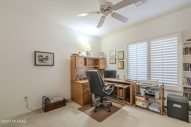 office area with carpet floors, visible vents, and a ceiling fan