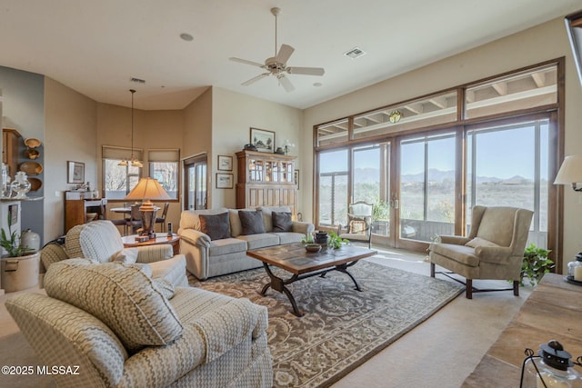 living area with a mountain view, a wealth of natural light, and visible vents