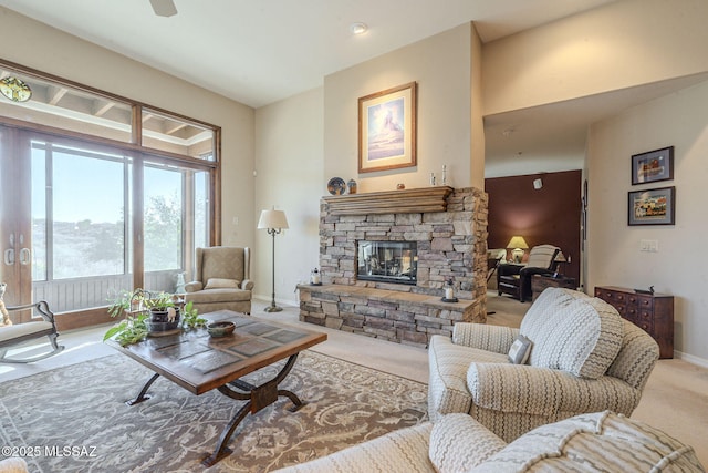 living room with carpet, a fireplace, and baseboards