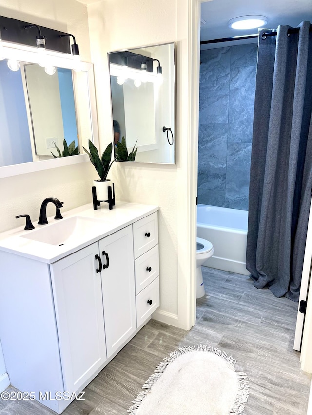 full bathroom featuring shower / tub combo, vanity, toilet, and wood finished floors