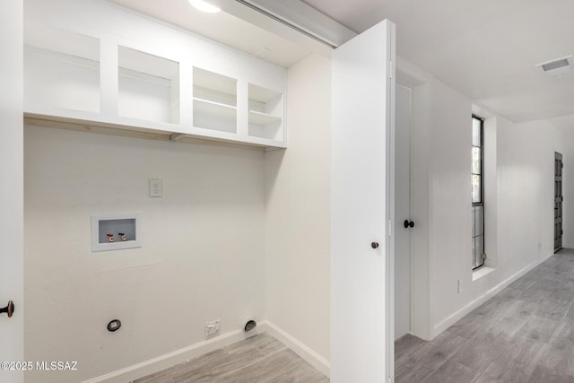 laundry room featuring hookup for a washing machine, visible vents, light wood-style flooring, laundry area, and baseboards