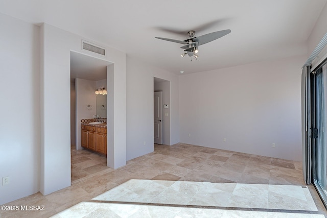 empty room with a ceiling fan, visible vents, and a sink