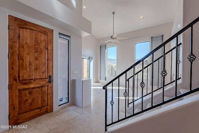 foyer with light tile patterned floors, stairway, a ceiling fan, and recessed lighting