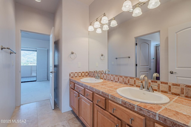 bathroom featuring double vanity, tile patterned flooring, decorative backsplash, and a sink