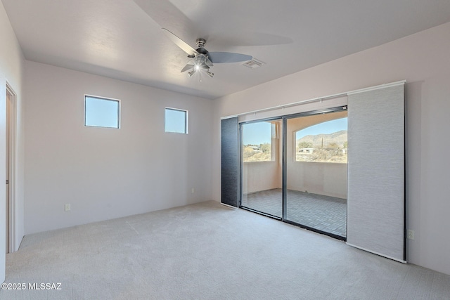 unfurnished room with light carpet, ceiling fan, and visible vents