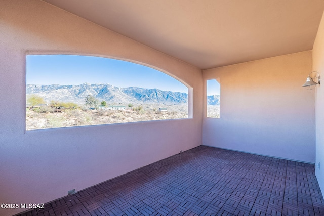 view of patio with a balcony and a mountain view