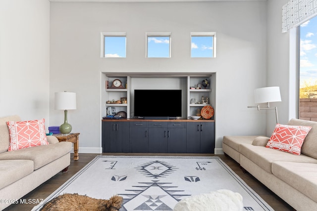 living room with dark wood-style flooring and baseboards