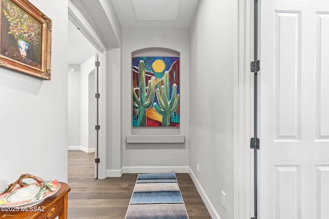 doorway to outside with baseboards and wood finished floors