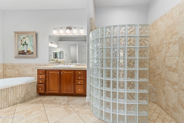 full bath with tile patterned flooring, walk in shower, a bath, and vanity