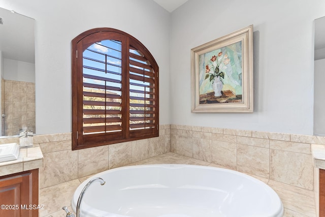 full bath featuring a garden tub and vanity