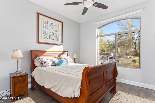 bedroom with ceiling fan, baseboards, and dark wood-type flooring