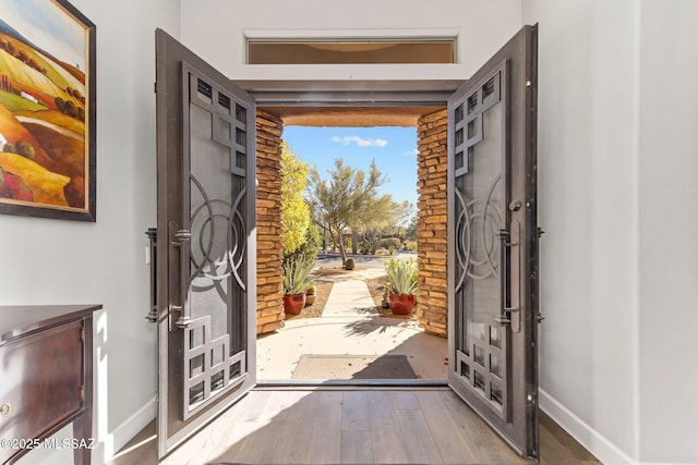 entryway featuring wood-type flooring and baseboards