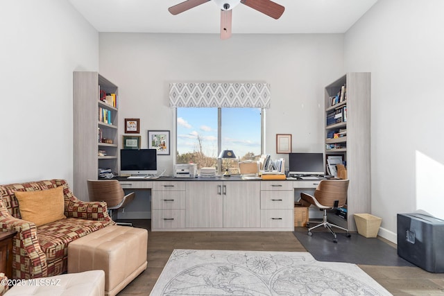 office area featuring a ceiling fan, built in desk, and wood finished floors