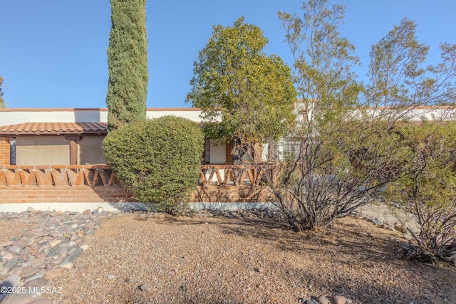 view of front of house featuring a tiled roof and stucco siding