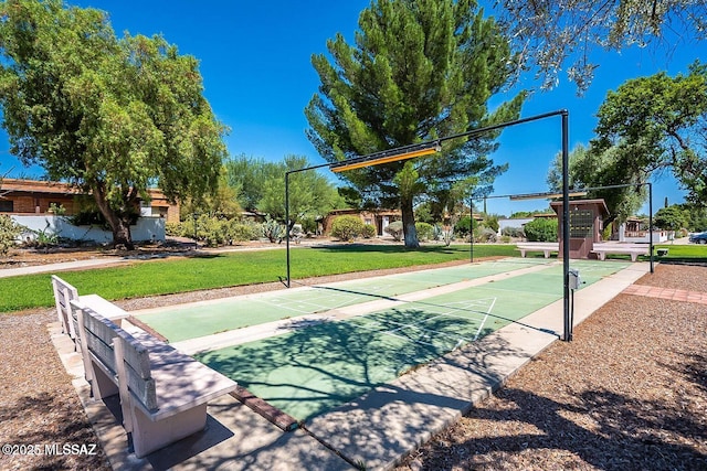 view of sport court featuring a yard