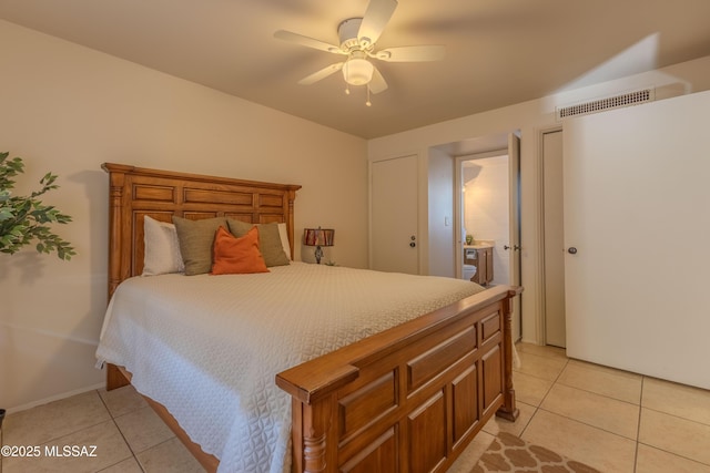 bedroom featuring a ceiling fan, visible vents, and light tile patterned floors