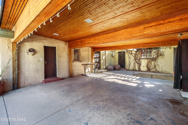 interior space featuring unfinished concrete flooring and track lighting