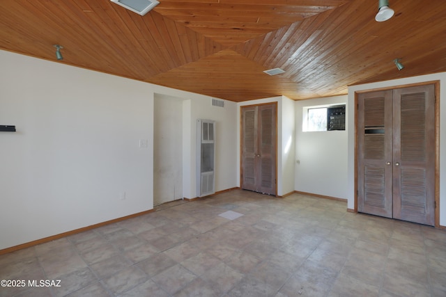 unfurnished bedroom with wooden ceiling, visible vents, baseboards, and two closets