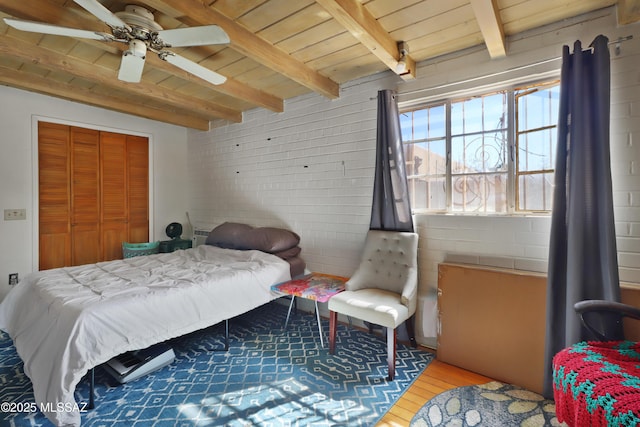 bedroom with ceiling fan, wooden ceiling, beamed ceiling, and wood finished floors