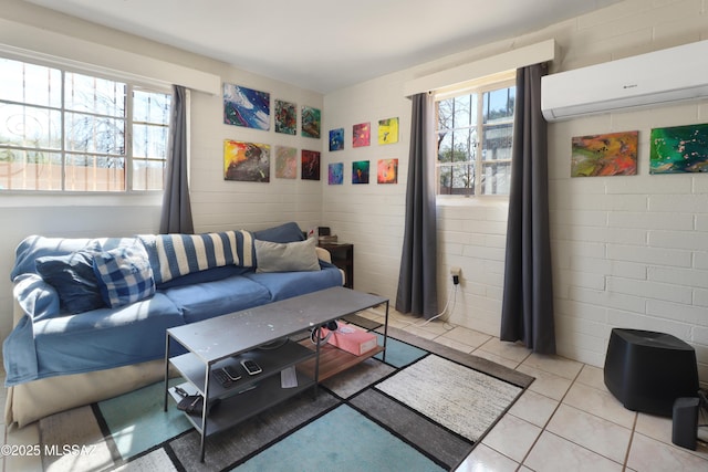 living room with plenty of natural light, a wall unit AC, and light tile patterned flooring