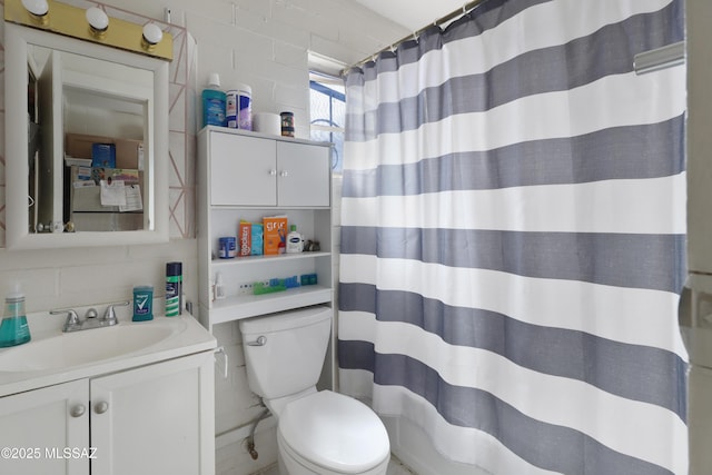 full bathroom with tile walls, backsplash, a shower with shower curtain, toilet, and vanity