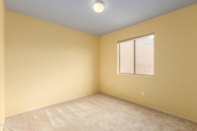 empty room with carpet flooring and baseboards