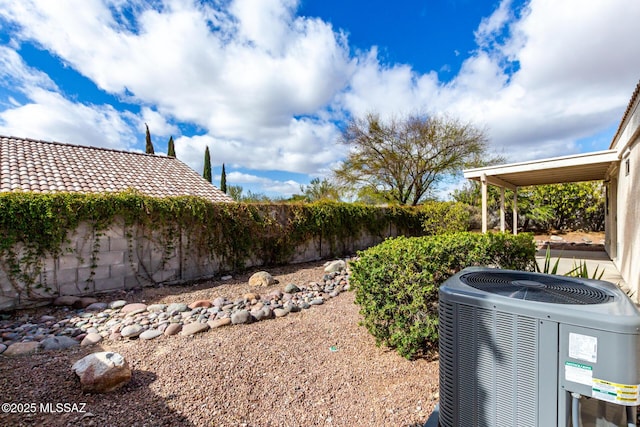 view of yard with fence and cooling unit