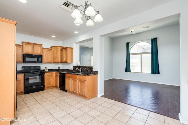 kitchen featuring light tile patterned floors, a notable chandelier, a sink, visible vents, and black appliances