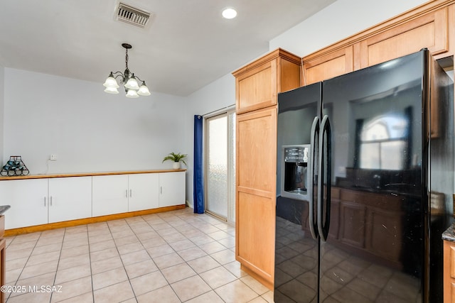 kitchen with pendant lighting, a notable chandelier, light tile patterned floors, visible vents, and black fridge with ice dispenser