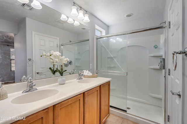 bathroom with a stall shower, tile patterned flooring, plenty of natural light, and a sink