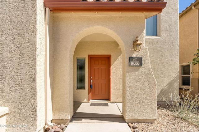 entrance to property featuring stucco siding