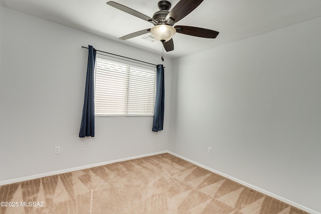 unfurnished room featuring ceiling fan, visible vents, baseboards, and light colored carpet