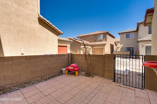 view of patio / terrace with a residential view and fence