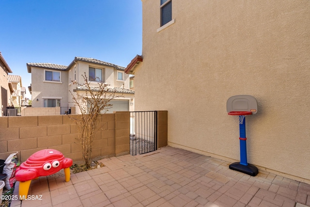 view of patio with fence and a gate