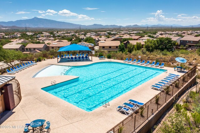 pool with fence and a mountain view