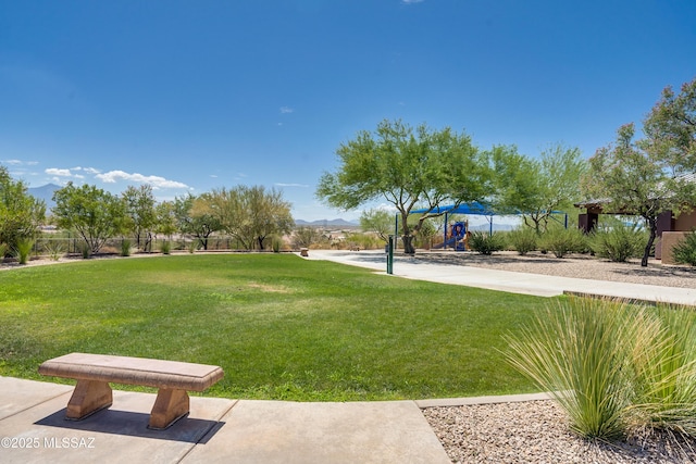 surrounding community with playground community and a lawn