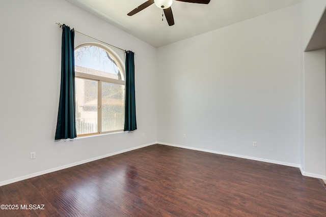 unfurnished room with dark wood-type flooring, ceiling fan, and baseboards