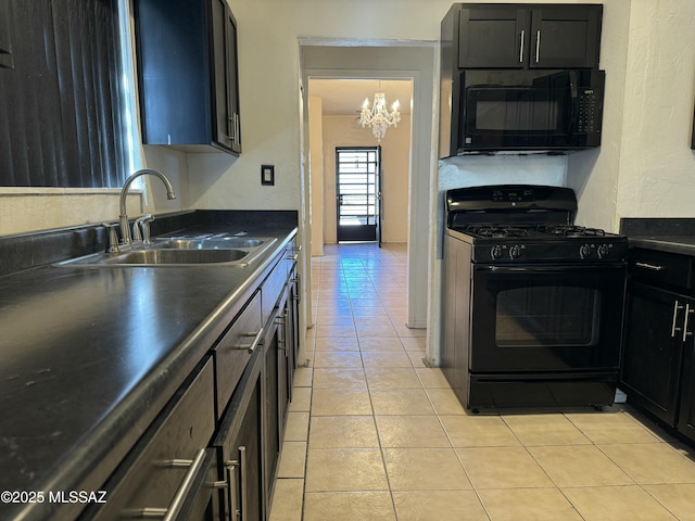 kitchen featuring dark countertops, light tile patterned flooring, a sink, dark cabinets, and black appliances