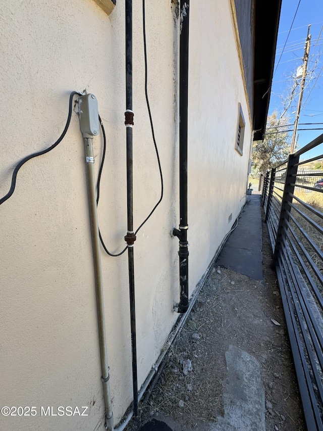 view of home's exterior featuring fence and stucco siding